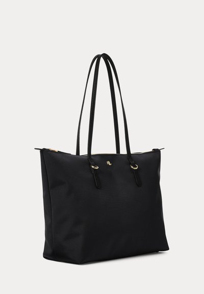 Sac cabas structuré noir avec longues anses doubles, fermeture éclair dorée et petit logo doré au centre avant.