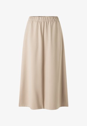 Pantalon large beige à taille élastique, coupe ample et tissu lisse, présenté de face sur un fond blanc.