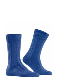 Chaussettes en coton ribbé bleu avec une finition texturée, dotées d'un poignet replié et d'une coupe ajustée pour le confort et le soutien.