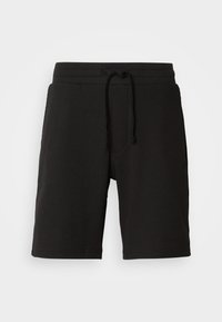 Pantaloni corti neri in maglia con un tessuto testurizzato, cintura elastica, cordoncino regolabile e tasche laterali. La lunghezza arriva sopra il ginocchio.