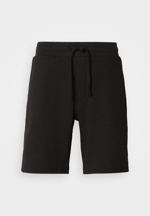 Fekete kötött rövidnadrág texturált anyagból, rugalmas derékrésszel, állítható zsinórral és oldalsó zsebekkel. Hossza a térd fölött ér véget.