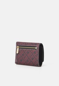 Folded wallet made of textured burgundy and black material, featuring a zip pocket and gold-tone hardware with a decorative pattern.