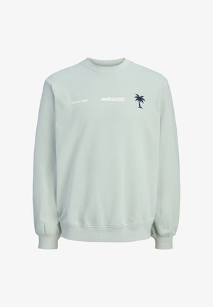 Sweat-shirt gris clair avec poignets et ourlet côtelés, arborant un texte blanc "jack & jones since 1990" et un petit motif de palmier bleu marine sur la poitrine.