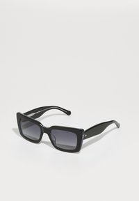 Óculos de sol retangulares pretos com lentes cinza degradê; estrutura de plástico brilhante e hastes afuniladas; detalhe discreto do logótipo na lateral.