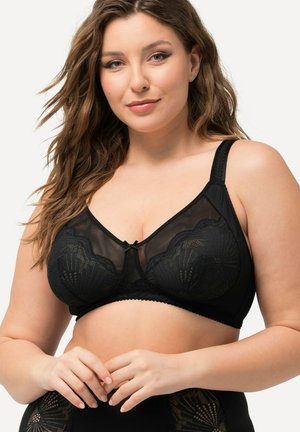Zwarte bh met een doorschijnend netdesign, golvende kantaccenten, verstelbare bandjes en een klein strikje in het midden. Over het algemeen een gladde textuur.