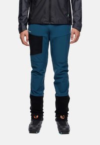 Blauwe skibroek met een zwart zijvak, elastische manchetten en verstevigd stof aan de onderkant. Soepele textuur en nauwsluitend ontwerp.