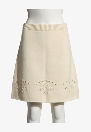 Jupe tricotée crème longueur genou avec taille côtelée et motif floral délicat découpé près de l'ourlet.