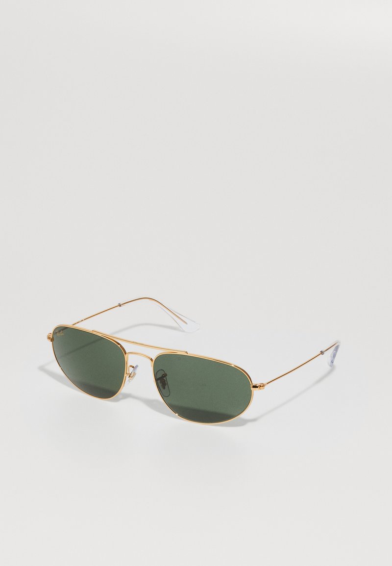 Occhiali da sole in metallo dorato con lenti verde scuro, forma ovale, montatura in filo sottile, cuscinetti nasali in acetato e punte delle tempie in gomma trasparente.