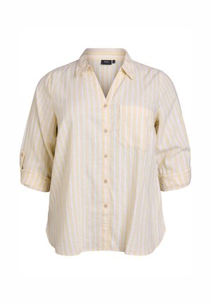 Žlto-biele pruhované košeľa s gombíkmi, golierom a náprsníkom. Má rukávy po lakeť, ktoré sú vyhrnuté pri manžetách.