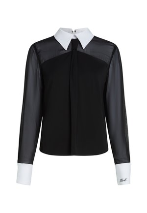 Black long-sleeve blouse with sheer sleeves, white collar and cuffs, front pleat detail, and embroidered signature on the cuff.