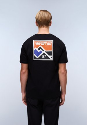 Black cotton t-shirt featuring a multicolored graphic design with mountains and "NAPAPIJRI 87" text on the back. Short sleeves, relaxed fit.