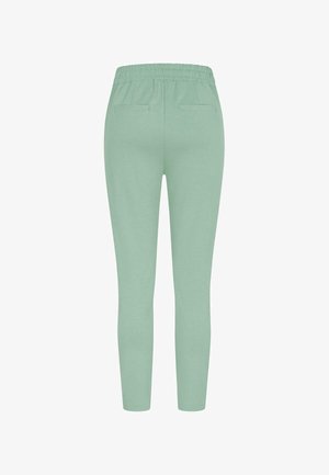 Mentrohelised spordipüksid elastse vöökoha, kitsas istuvus ja kahe tagataskuga. Pehme kangas sileda tekstuuriga ja ilma nähtavate mustriteta.