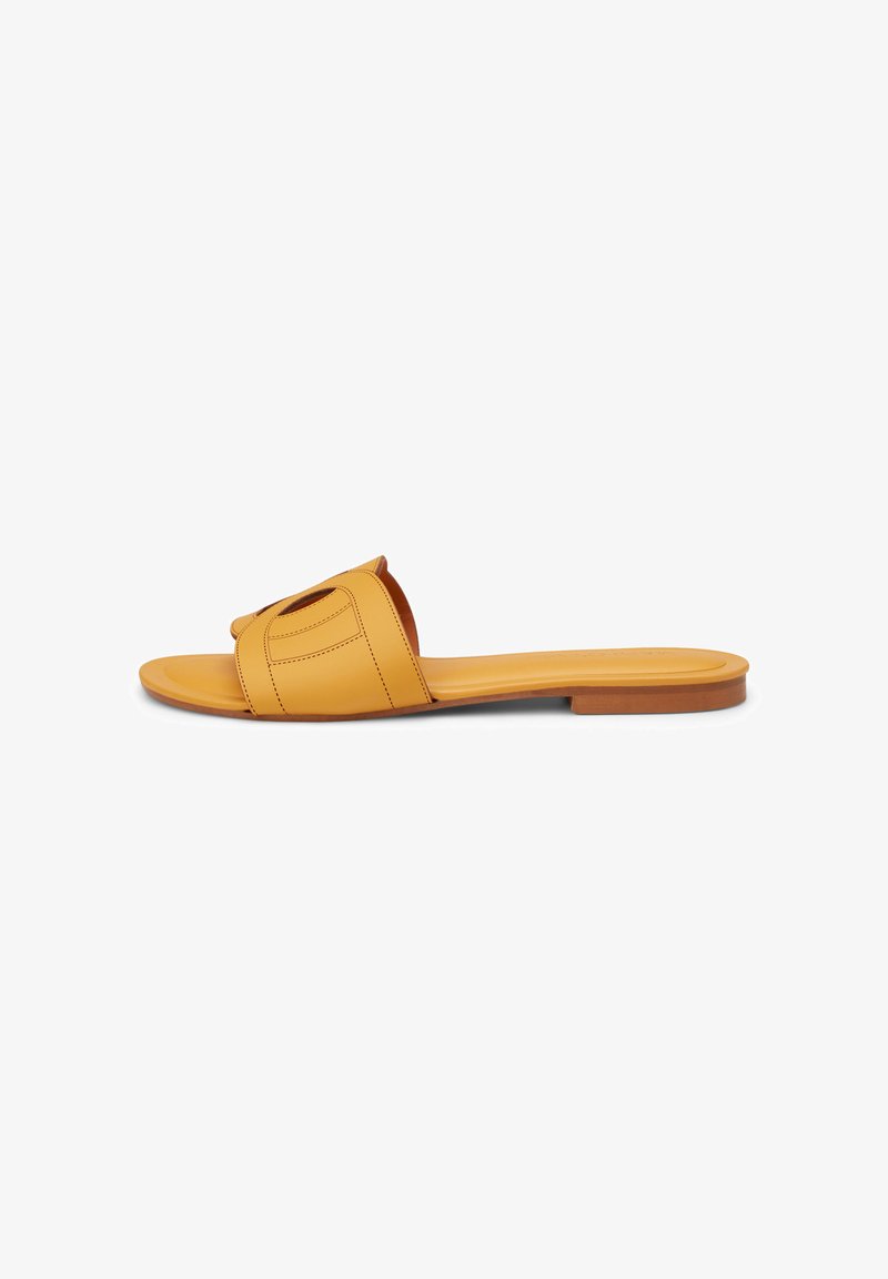 Yellow slide sandals with a wide strap featuring a cut-out design, set against a white background.