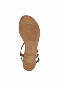 Semelle de sandale marron tan avec une texture antidérapante, design plat et bride de cheville ajustable. Nom de la marque et taille 37 estampés sur la semelle intérieure.