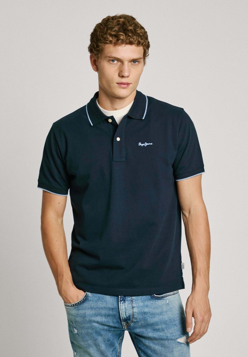 Navy polo shirt with a three-button placket and light blue accents on the collar and sleeves. Embroidered logo on the left chest.