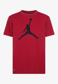 Camiseta corta roja de algodón, con un gran logo negro de Jumpman centrado en la parte delantera. Diseño de cuello redondo, corte relajado.