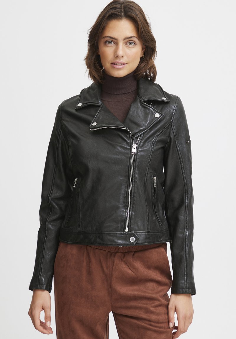Black leather motorcycle jacket with zip fastening, asymmetrical design, silver hardware accents, and a fitted silhouette.