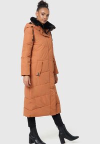 Long, orange puffer coat with a black faux fur collar, vertical quilted pattern, side pockets, and adjustable drawstring hood.