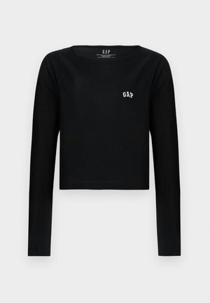 Černý dlouhý rukáv crop top vyrobený z bavlny s kulatým výstřihem a bílým vyšitým logem "GAP" na hrudi. Hladká textura.