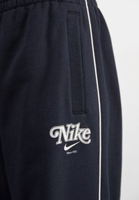 Nike Sportswear STRAIGHT PANT - Tracksuit bottoms - black