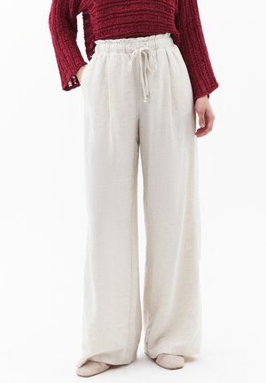 Wide-leg trousers made of light beige linen, featuring an elasticated waistband with a drawstring, smooth texture, and side pockets.
