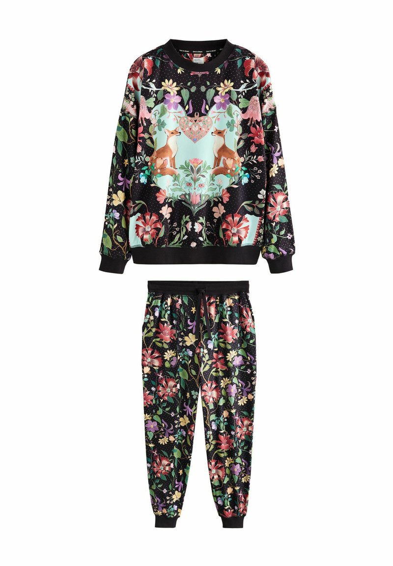 Black floral sweatshirt and joggers set with fox and heart motif on top, featuring colorful flowers and green leaves throughout.