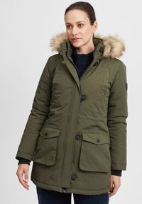 Olive green padded parka jacket with a fur-lined hood, front button closure, and two large front pockets. Features ribbed cuffs and a slightly curved hem.