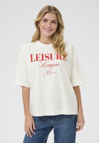 White oversized t-shirt with short sleeves, featuring red printed text "LEISURE League" and established year "est. 1998" at the center.