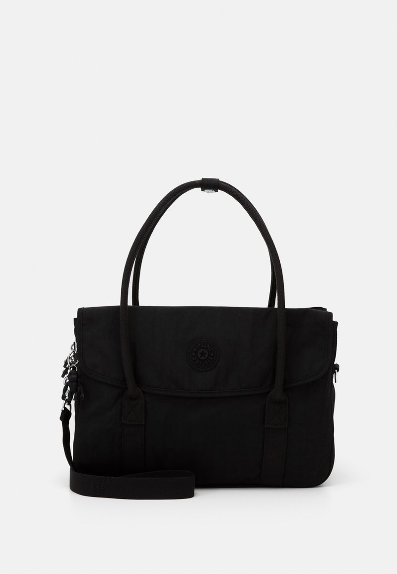 Black canvas handbag with dual handles, adjustable shoulder strap, flap closure, and logo accent. Smooth texture and sleek design.
