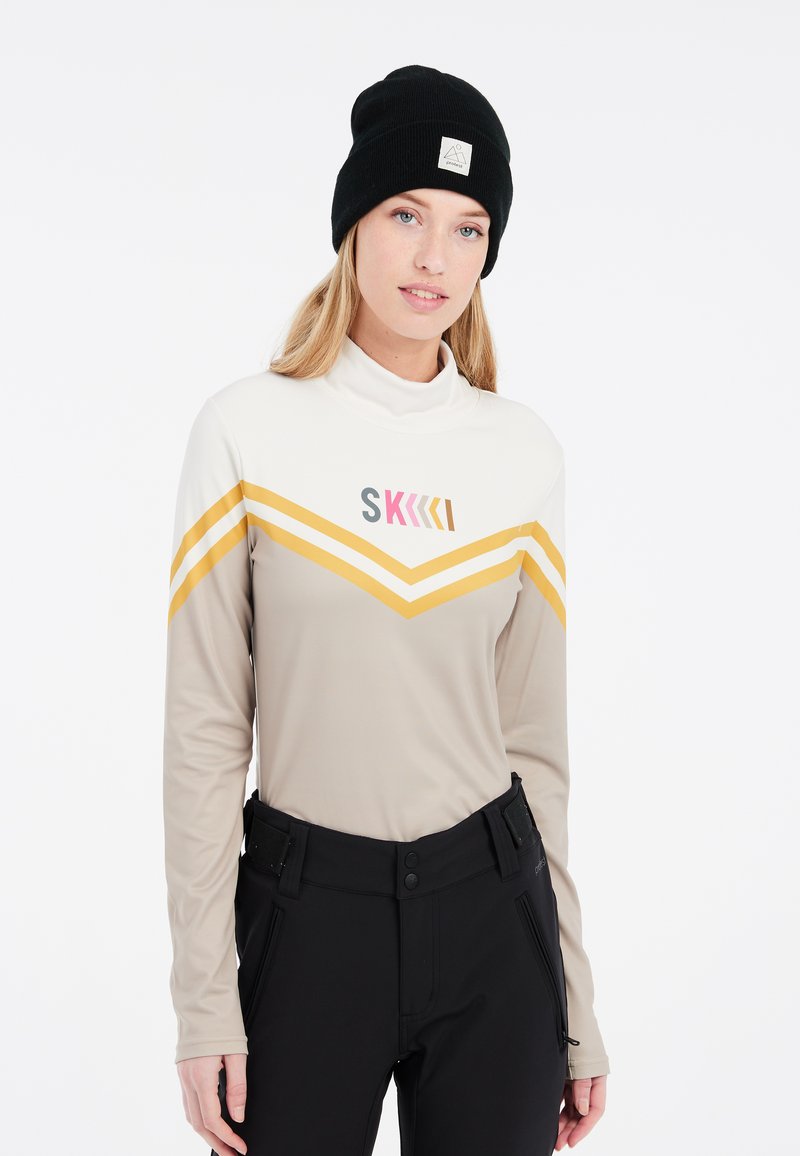 Langärmliges Skitop in Beige mit gelben Chevronstreifen und pinkfarbener Grafik. Verfügt über einen hohen Kragen und einen leichten, dehnbaren Stoff.
