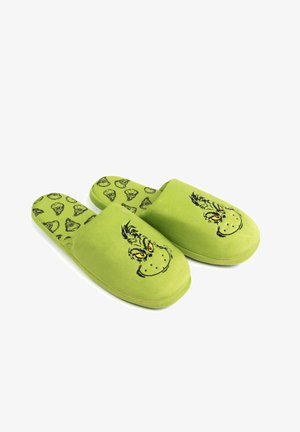 Green slippers with a soft texture, featuring a Grinch face design on the front and a repeated Grinch pattern on the insole.