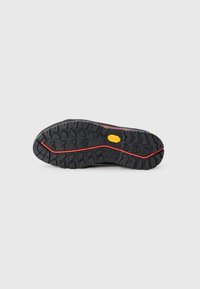 Black hiking shoe sole with deep treads, featuring a prominent red stripe and a yellow accent. Textured rubber material for grip.
