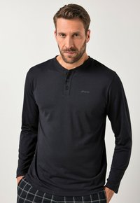 Black long-sleeve henley shirt featuring a crew neck, three-button placket, and a subtle logo. Made of smooth, lightweight fabric.