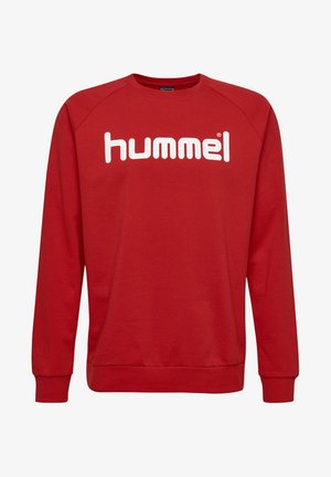 Rode sweatshirt met een ronde halslijn en lange raglanmouwen. Op de voorkant staat het woord "hummel" in grote witte letters.