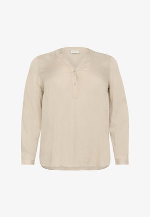 Beżowa bluzka z długim rękawem z miękkiego materiału, z dekoltem w kształcie litery V, listwą z guzikami oraz mankietami z zaokrąglonym końcem.