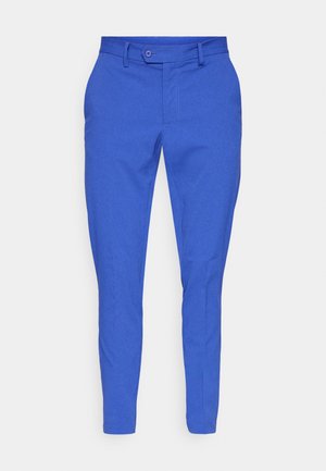 Blue slim-fit trousers made of textured fabric. Features a button closure, belt loops, and tapered ankles for a modern design.