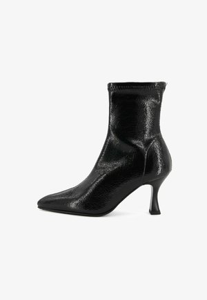 Black patent leather ankle boot with pointed toe and slim mid-height curved heel, side profile on white background.