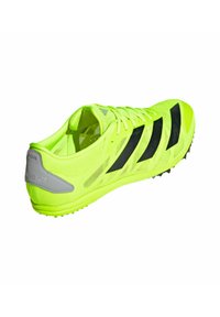 Scarpa sportiva gialla brillante con strisce nere, realizzata in mesh. Presenta un design leggero, suola testurizzata e pannello del tallone rinforzato.