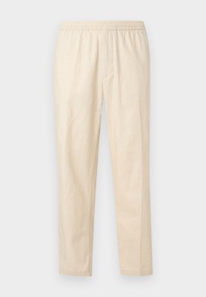 Heledat beeži sirgete säärega püksid elastse vöökohaga ja ilma nähtavate taskute või kaunistusteta, valgel taustal.