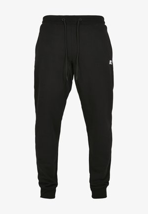 Sorte sweatpants lavet af bomuld, med snøre i taljen, elastiske manchetter og et lille logo på venstre hofte foran.