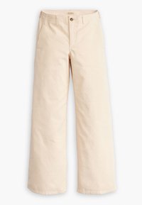 Vaaleat leveälahkeiset corduroyhousut, joissa on vyölenkit, sivutaskut, etunappi ja vetoketjukiinnitys, asetettuna tasaiselle valkoiselle taustalle.