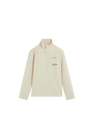 Jersey de manga larga color crema con cuello de media cremallera y un bolsillo en el pecho con botón que lleva el logo de Scalpers.