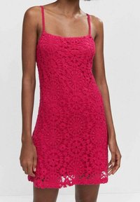 Robe en dentelle rouge avec un décolleté carré, des fines bretelles et une silhouette droite. Présente un motif floral et un ourlet en dentelle.