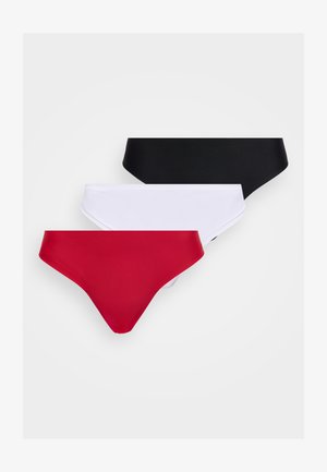 Tre sømløse bikini-trusser i sort, hvid og rød, arrangeret overlappende på en ensfarvet hvid baggrund.