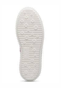 White rubber shoe sole with circular and oval tread patterns, featuring horizontal grooves and a raised logo in the center.
