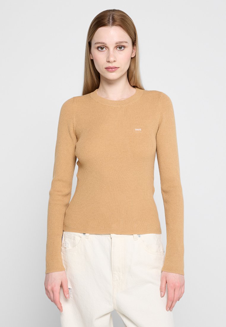 Beige geripptes Langarmshirt mit Rundhalsausschnitt und figurbetontem Schnitt. Mit kleinem Logo auf der Brust, aus weichem, dehnbarem Material gefertigt.