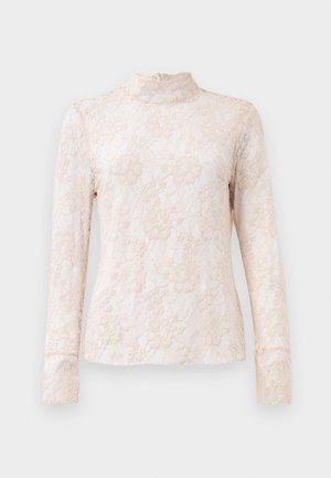 Blonde bluse med lange ærmer i blød beige med høj halsudskæring. Har blomster mønstre, gennemsigtig tekstur og en subtil lynlås på ryggen.
