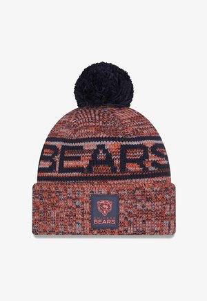Knit beanie in orange and navy with a pom-pom on top, featuring a bold "BEARS" pattern and a branded logo patch on the cuff.