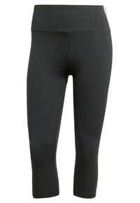 Svarta åtsittande leggings med hög midja, med vita sidostripes, tillverkade av stretchigt och mjukt material. Capris-längd, utan synliga fickor.