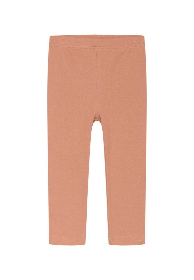Leggins u boji breskve napravljeni su od mekog, rastezljivog materijala s elastičnom pasiom. Dizajn uključuje prilagođeni siluet i nema uzoraka ili naglasaka.
